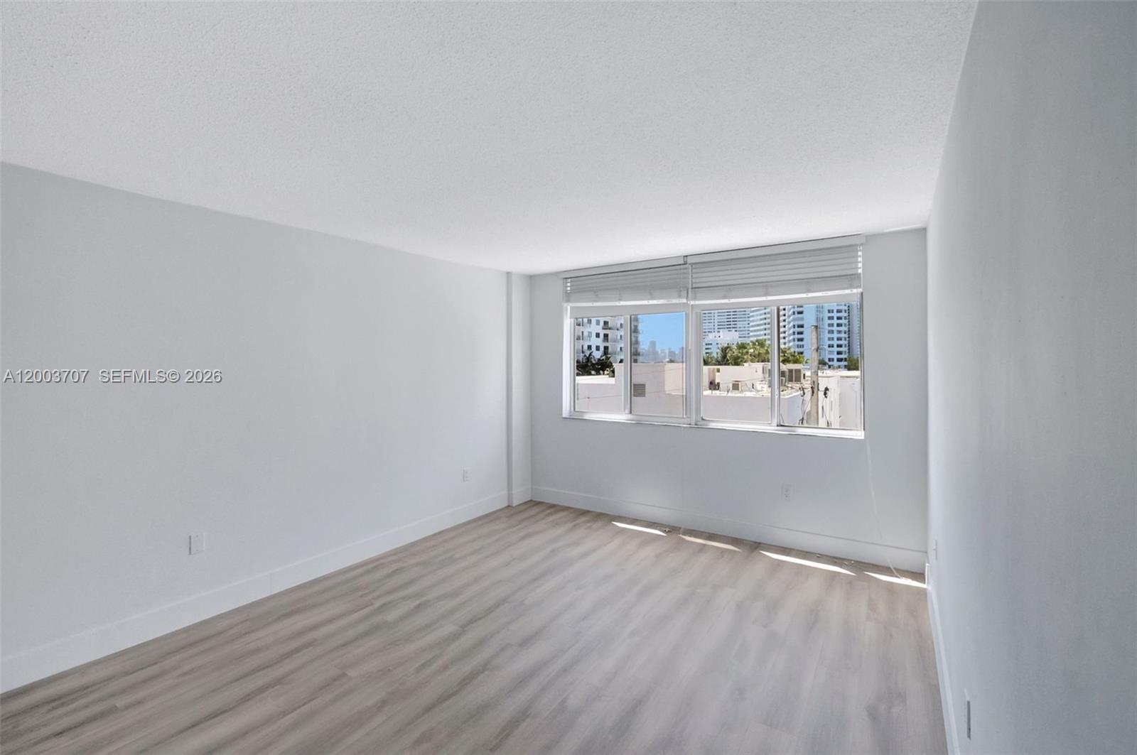 1345 Lincoln Road, Unit 501 Miami Beach, FL 33139 - Photo 18 of 33 a view of a big room with wooden floor and windows in kitchen