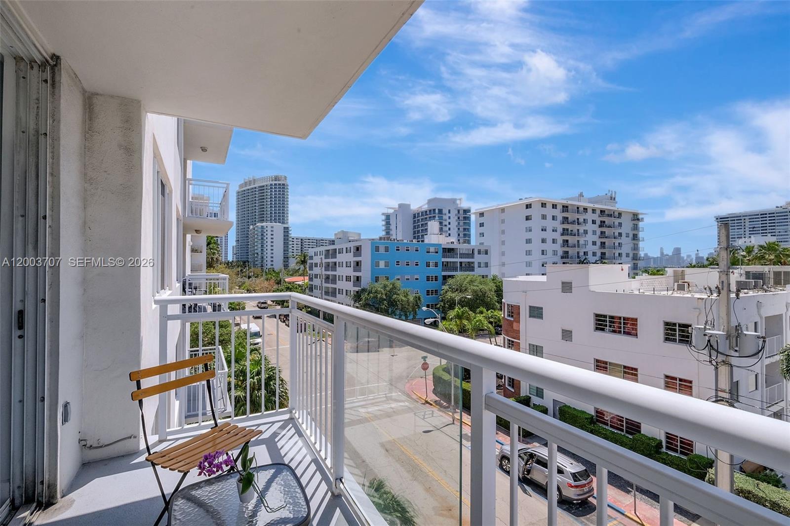 1345 Lincoln Road, Unit 501 Miami Beach, FL 33139 - Photo 9 of 33 a view of a balcony with wooden benches
