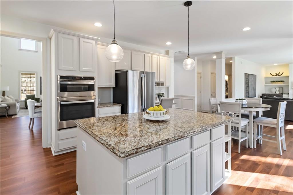6233 Huntington Ridge Road Mableton, GA 30126 - Photo 19 of 50 a kitchen with stainless steel appliances granite countertop a sink refrigerator and cabinets