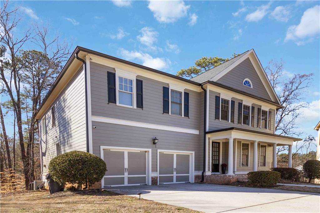 6233 Huntington Ridge Road Mableton, GA 30126 - Photo 2 of 50 a front view of a house with garden