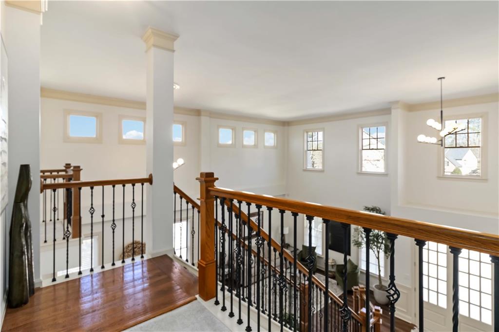 6233 Huntington Ridge Road Mableton, GA 30126 - Photo 21 of 50 a view of staircase with railing and a chandelier