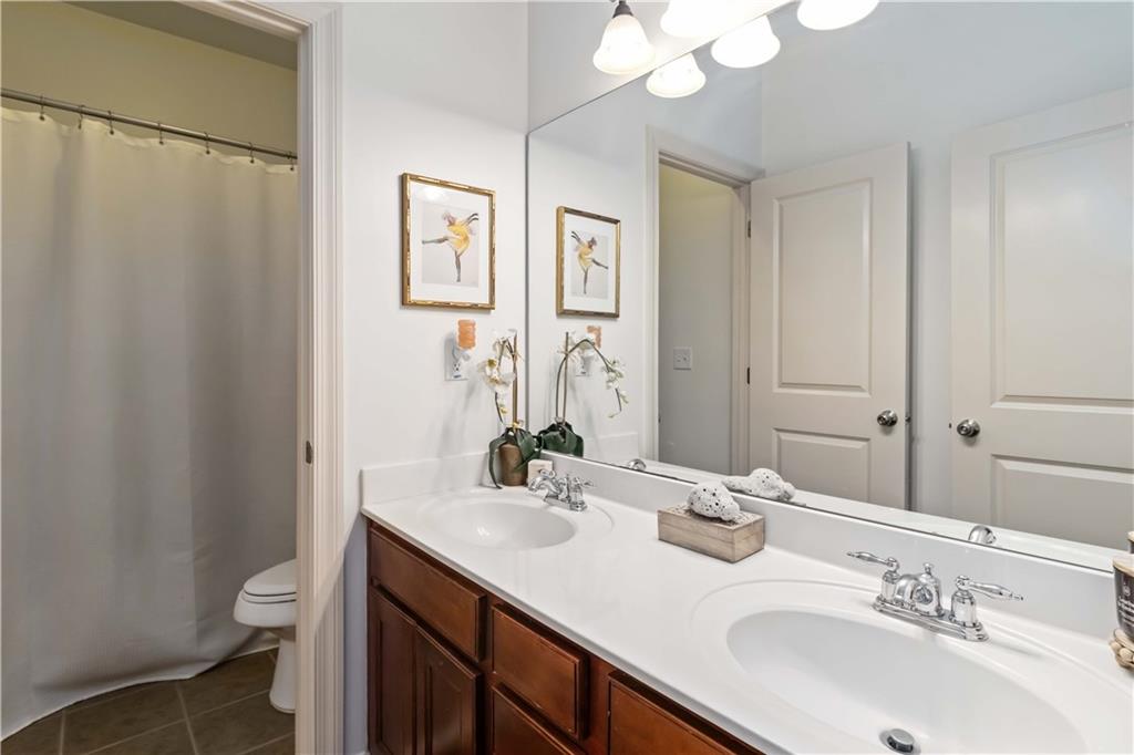 6233 Huntington Ridge Road Mableton, GA 30126 - Photo 36 of 50 a bathroom with a double vanity sink mirror and toilet