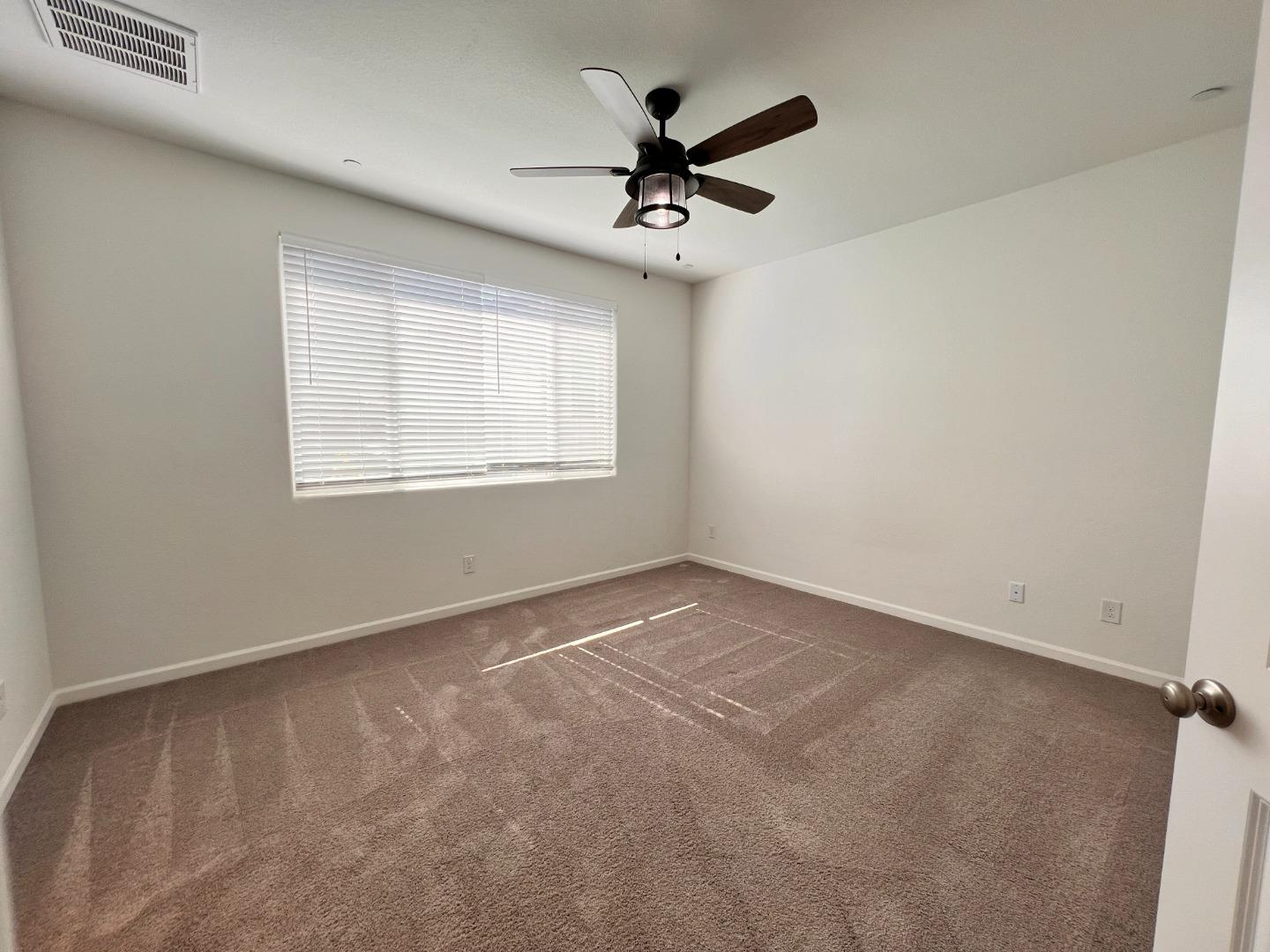 8362 Lemberger Way Sacramento, CA 95829 - Photo 14 of 28 an empty room with a window and a fan