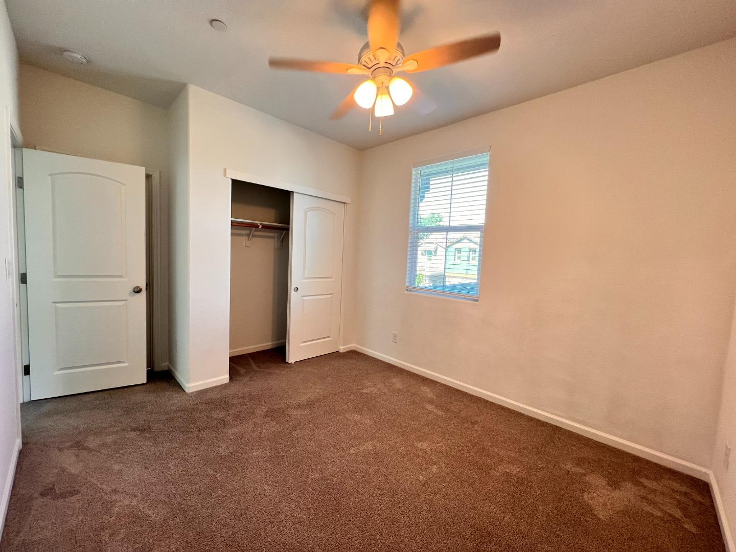 8362 Lemberger Way Sacramento, CA 95829 - Photo 17 of 28 an empty room with windows and fan
