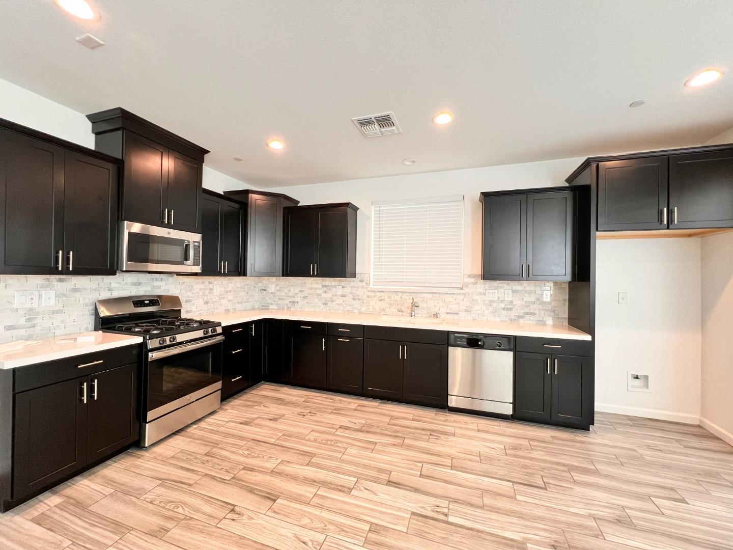 8362 Lemberger Way Sacramento, CA 95829 - Photo 5 of 28 a large kitchen with granite countertop a large counter top stainless steel appliances and cabinets