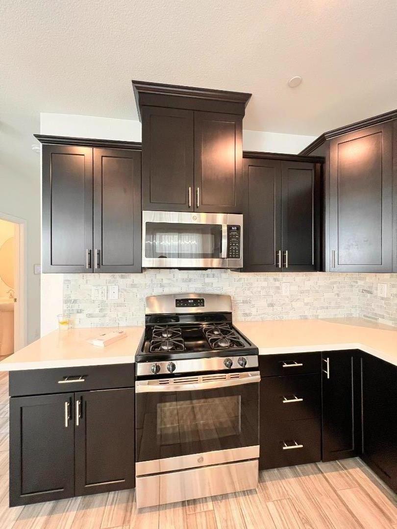 8362 Lemberger Way Sacramento, CA 95829 - Photo 6 of 28 a kitchen with stainless steel appliances granite countertop a stove and a sink