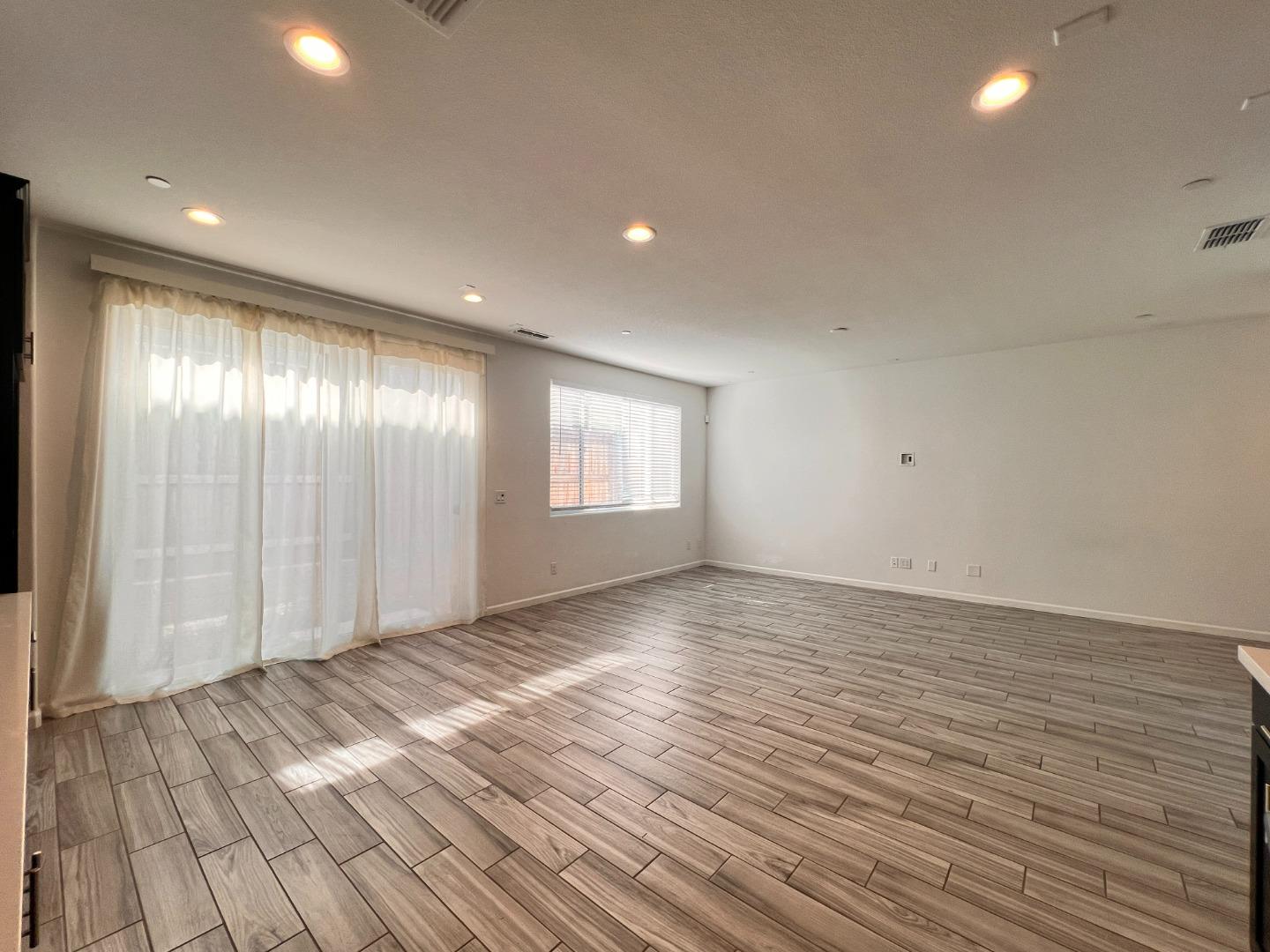 8362 Lemberger Way Sacramento, CA 95829 - Photo 10 of 28 an empty room with wooden floor and windows