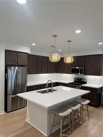 a kitchen with a table and chairs