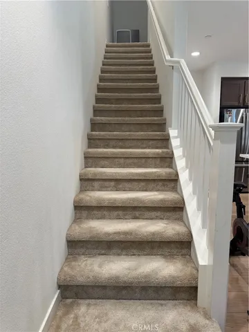 a bathroom with a granite countertop sink toilet mirror and a shower