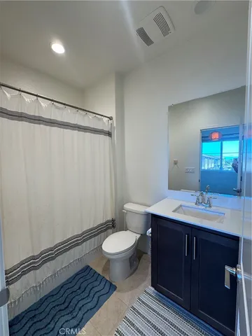a spacious bathroom with a double vanity sink and a mirror