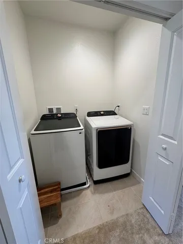 a close view of a utility room with washer and dryer