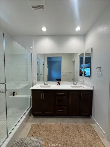 a bathroom with a tub sink shower and mirror