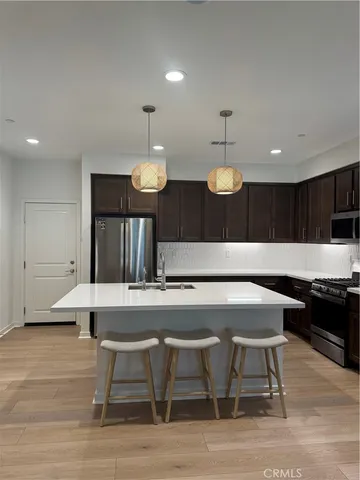 a large kitchen with a table and chairs in it