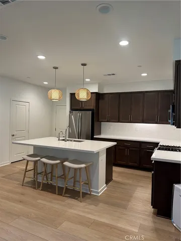 a kitchen with granite countertop a refrigerator and a sink