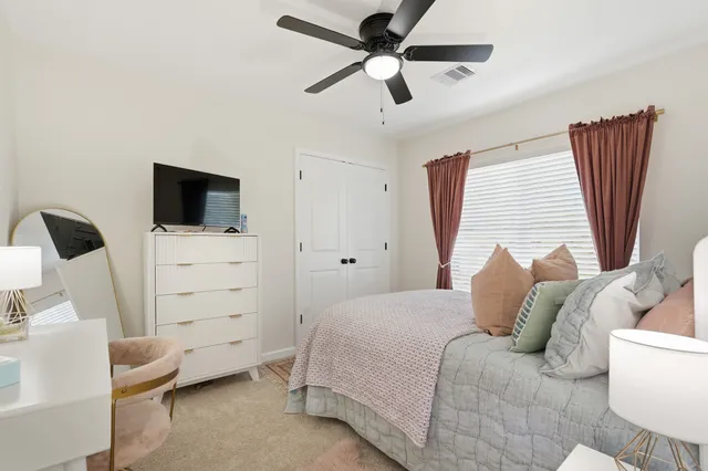 a bedroom with a bed and a television