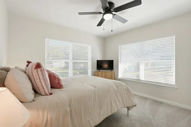 a bedroom with a large bed and a tv