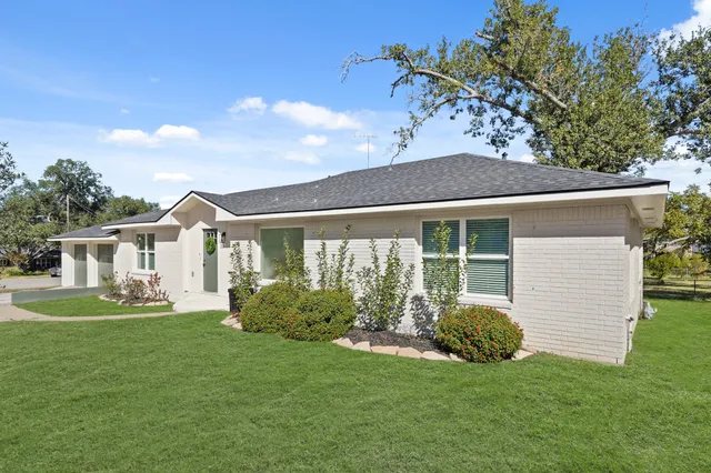 a front view of a house with a garden