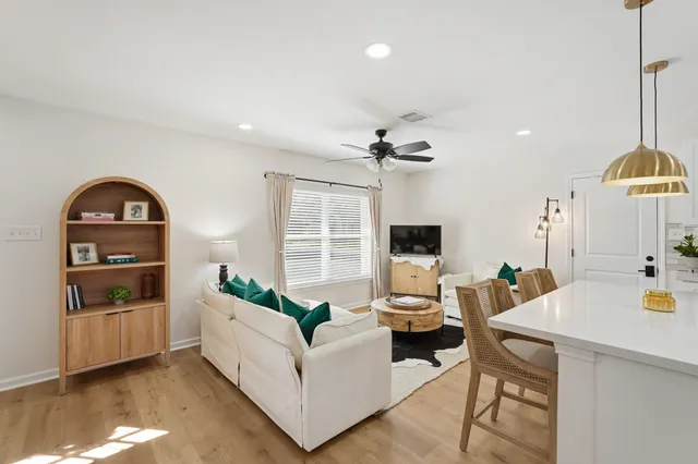 a living room with furniture and a wooden floor