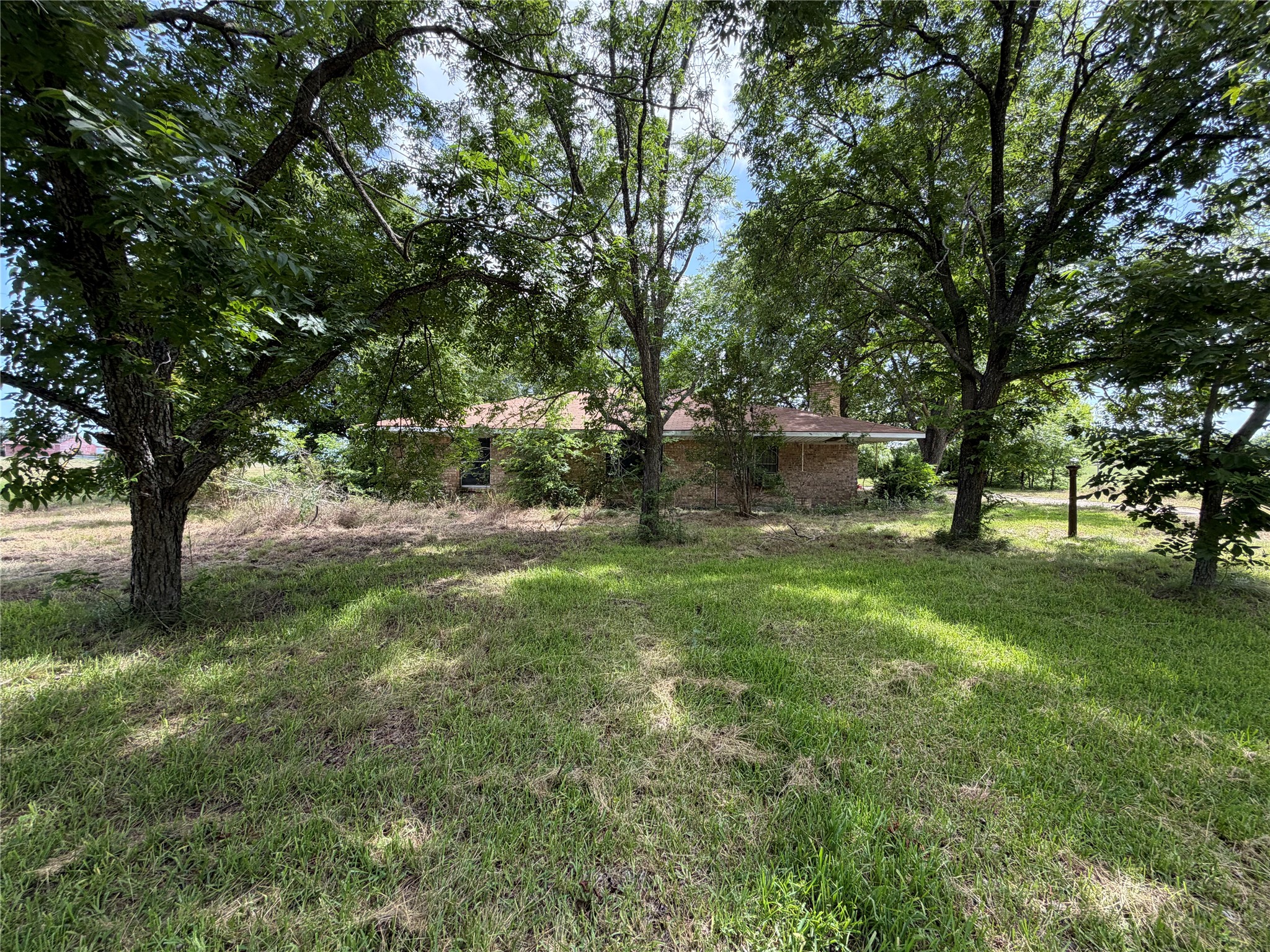 2501 Barnhardt Road Temple, TX 76502 - Photo 18 of 25 Mature trees offer shade and privacy around this charming brick-built home.