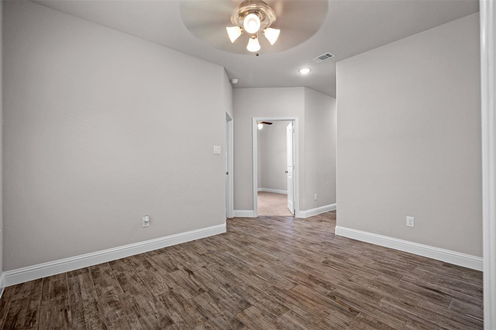 119 Happy Lane Red Oak, TX 75154 - Photo 17 of 37 Interior space featuring wood-finish flooring, light neutral wall paint, and white baseboards