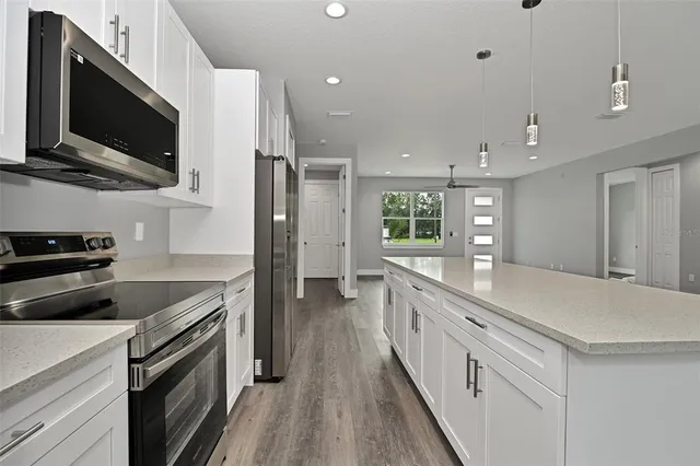 a kitchen with cabinets and stainless steel appliances