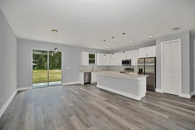 a view of a kitchen with wooden floor