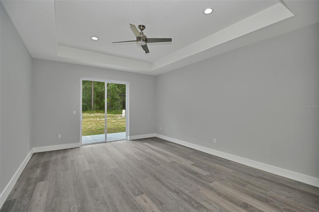 6237 Southwest 143rd Street Ocala, FL 34473 - Photo 20 of 35 a view of an empty room with a window and wooden floor