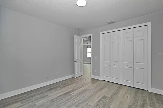a view of an empty room and wooden floor