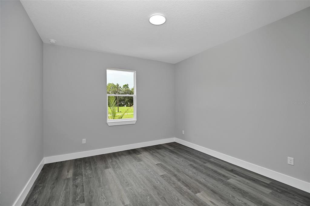 6237 Southwest 143rd Street Ocala, FL 34473 - Photo 27 of 35 wooden floor in an empty room with a window