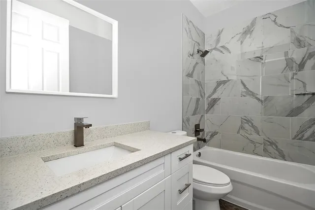 a bathroom with a sink a toilet and a bathtub