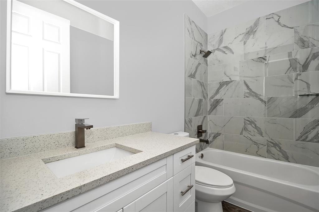 6237 Southwest 143rd Street Ocala, FL 34473 - Photo 29 of 35 a bathroom with a sink a toilet and a bathtub