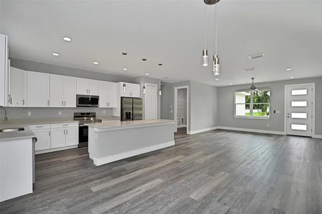 a view of kitchen with cabinets and wooden floor