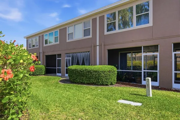 a view of a house with a yard and plants