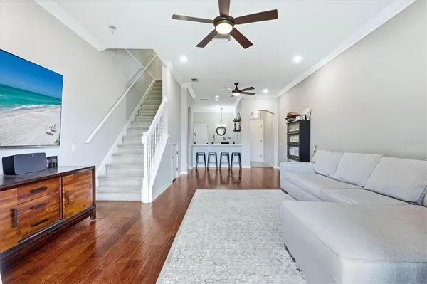 a living room with furniture and a wooden floor