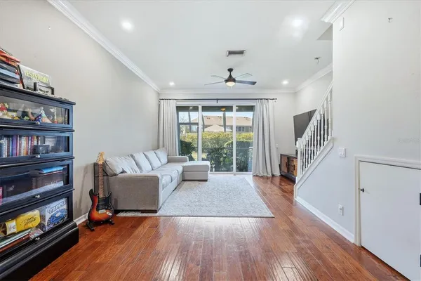 a living room with furniture and a wooden floor
