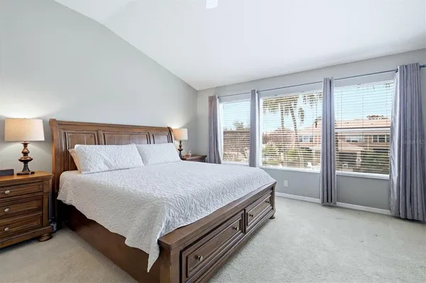 a bed sitting in a bedroom next to a window