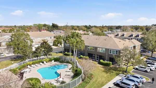 an aerial view of a house with swimming pool and lake view