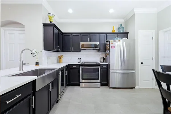 a kitchen with a refrigerator and a sink