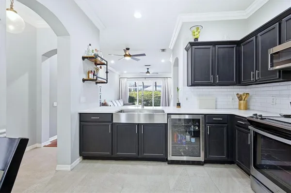 a kitchen with a sink stove top oven and cabinets