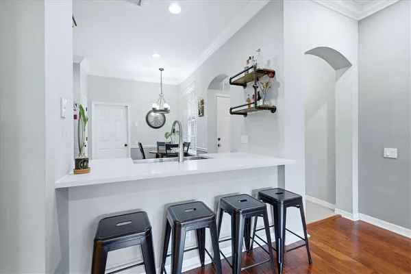 a view of a dining room with furniture and wooden floor