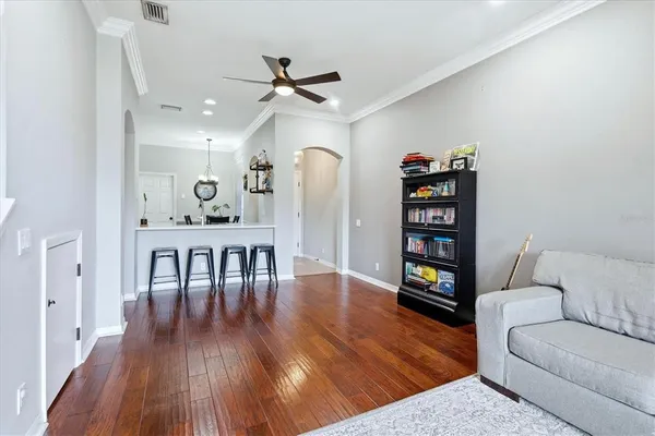 a living room with furniture and wooden floor