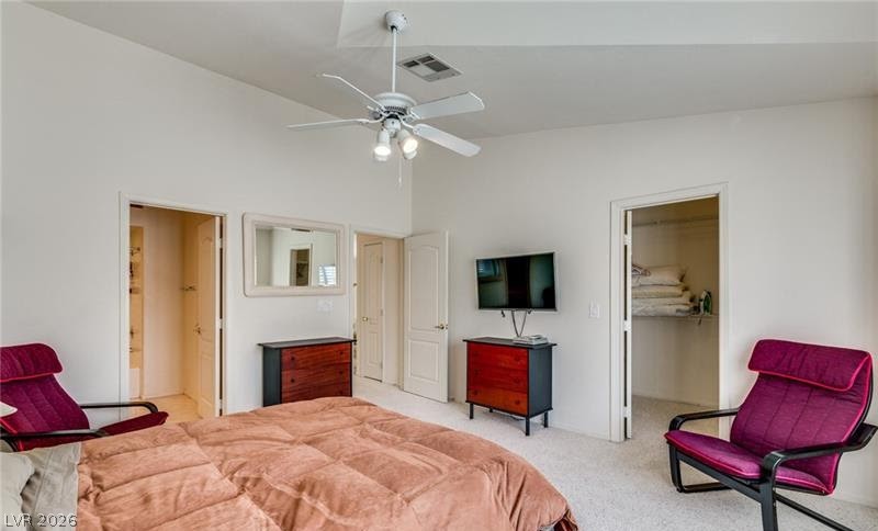 5272 Island Chain Road Las Vegas, NV 89118 - Photo 11 of 31 Relax in this well-lit primary bedroom featuring a vaulted ceiling and direct access to a private walk-in closet.