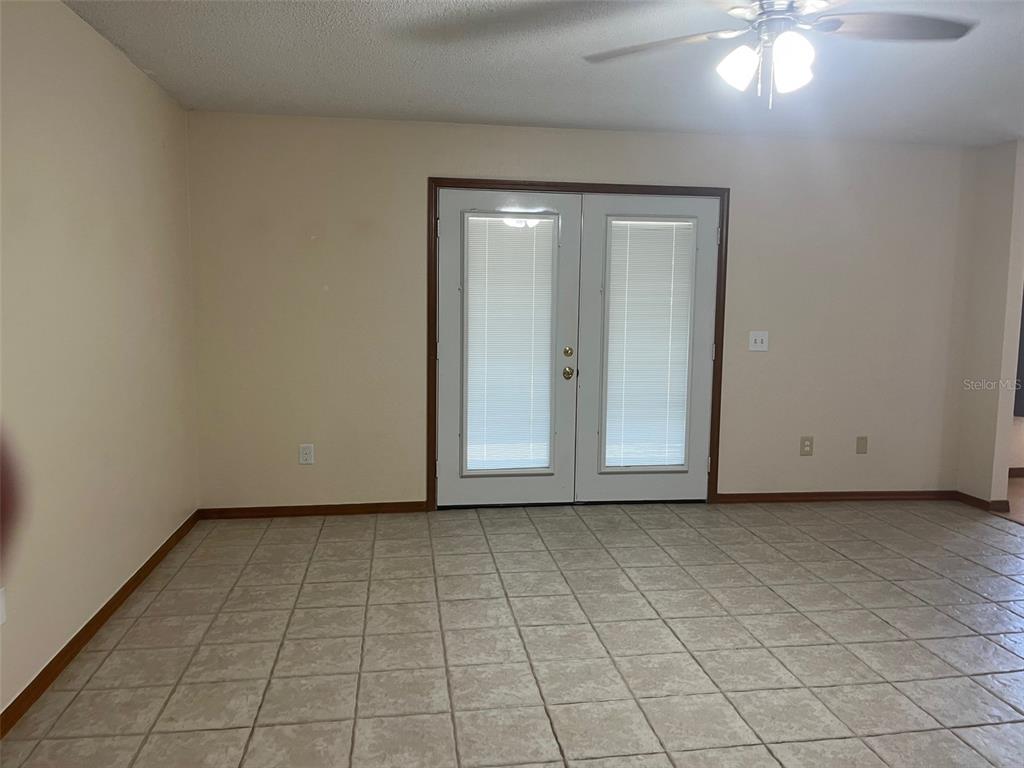 175 Conrad Street Port Orange, FL 32127 - Photo 3 of 13 a view of an empty room and chandelier fan