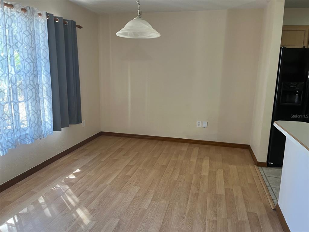 175 Conrad Street Port Orange, FL 32127 - Photo 6 of 13 wooden floor in an empty room with a window
