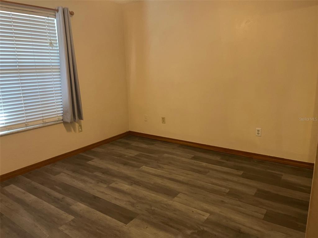 175 Conrad Street Port Orange, FL 32127 - Photo 8 of 13 a view of empty room with wooden floor and fan