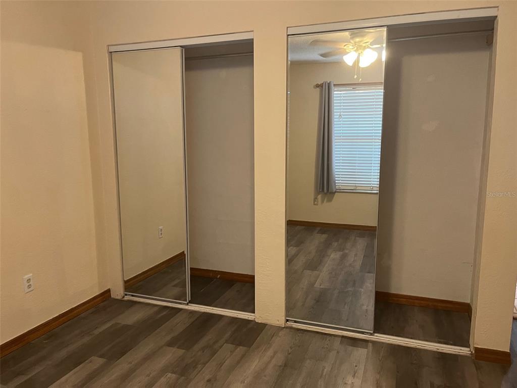 175 Conrad Street Port Orange, FL 32127 - Photo 9 of 13 an empty room with wooden floor and closet
