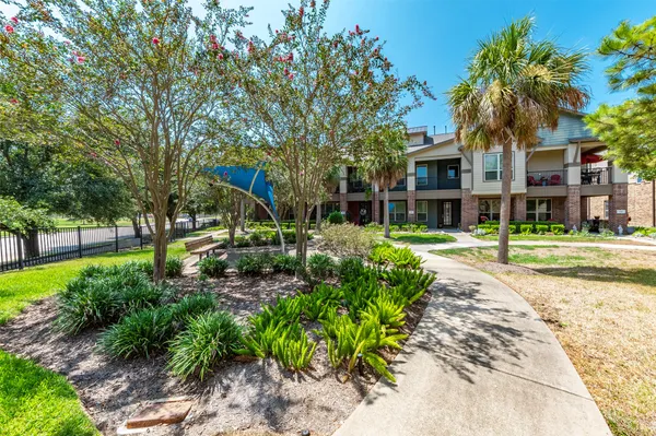 a front view of a house with a yard and a garage