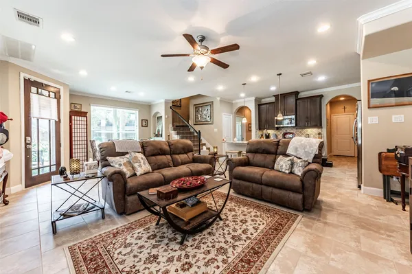 a living room with furniture ceiling fan and a rug