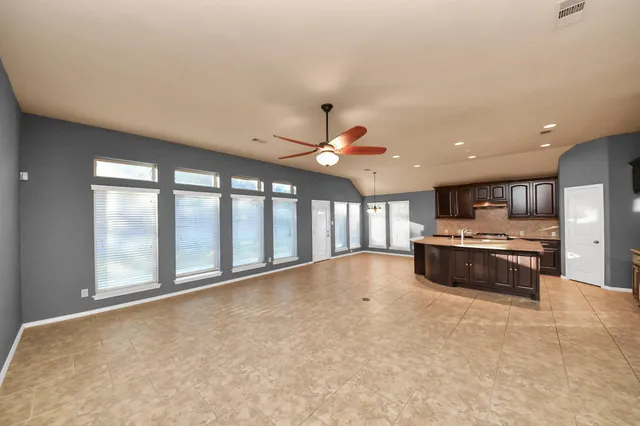 a kitchen with a sink and chairs