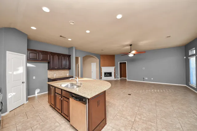 a view of a living room and kitchen with furniture